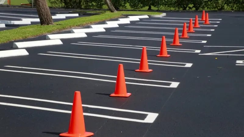Striped commercial parking lot outside an industrial building